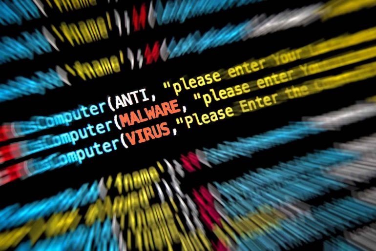 malware vs virus feature image showing a screen of code with those two words highighted
